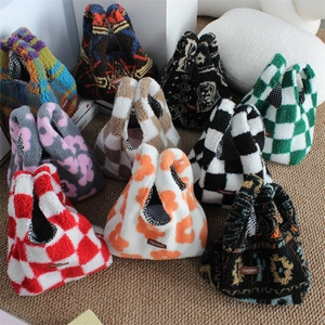 Various plush wrist bags featuring checkered and floral patterns with teddy fur texture