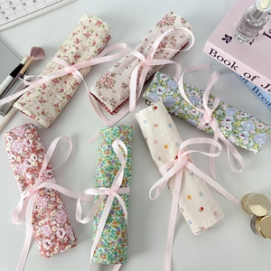 Roll-up floral fabric makeup brush bags with pink ribbons and elegant patterns