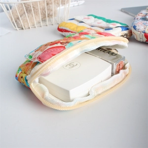 Detailed internal view of a quilted floral makeup bag holding cosmetic items