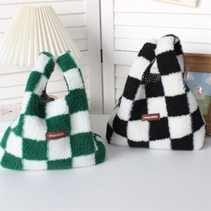 Detail of plush checkerboard handbags with soft faux fur texture and leather logo patch