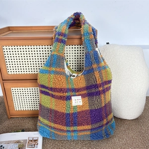 Detail of soft plush checkered tote bag with colorful pattern and brand label