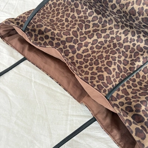 Detail of leopard print tote bag showing stitching quality and brown inner lining