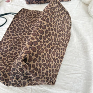Detail shot of the reinforced leopard print tote bag bottom with precision stitching
