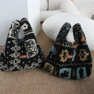 Detail of plush lamb wool handbags with ethnic patterns and brown leather logo tag