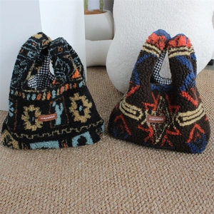 Close-up of plush tote bag showing colorful ethnic prints and soft lamb wool texture