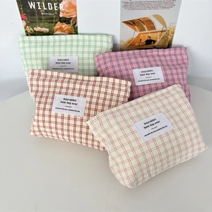 Gros plan de quatre pochettes à carreaux en seersucker en menthe, rose et bordeaux