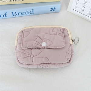 Detailed view of pink quilted floral coin purse with snap pocket and metal zipper closure