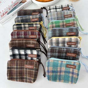 Flat lay of colorful plaid canvas coin purses in multiple colors and patterns