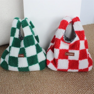Close-up of plush checkerboard wrist bag with soft lamb wool texture and leather label