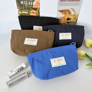 Macro detail of portable mini nylon makeup bags with zippers in four assorted colors