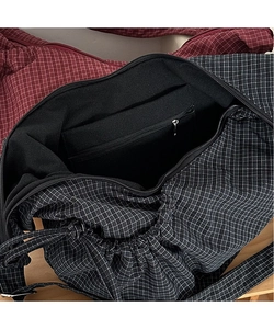 Detail of checkered canvas tote bag interior with drawstring and built-in zipper pocket