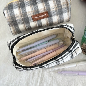 Close-up of large plaid wool pencil case with metal zipper and inner stationery storage