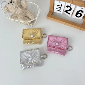 Three metallic puffy earphone cases in gold, silver, and pink with metal ring clips