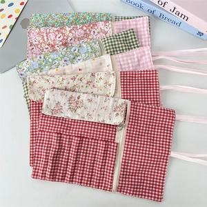 Floral fabric roll-up makeup brush bag with ribbon tie and heart zipper pull