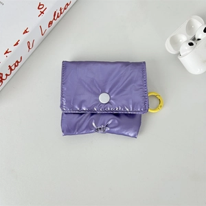 Macro shot of purple quilted puffer storage case for AirPods with yellow carabiner clip