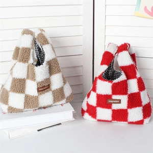 Detail of plush checkerboard handbags with fluffy fleece texture and leather logo tags