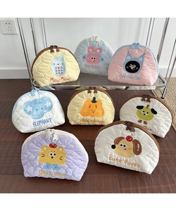 Close-up of quilted macaron color storage bags with animal embroidery and bear zippers