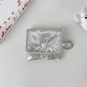 Close-up of a silver puffer storage case with a metallic finish and a secure snap button