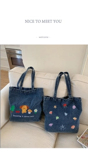 Detail of blue denim tote bags with cute puppy and colorful starfish embroidery patterns