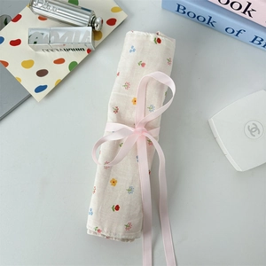 Floral makeup brush roll-up bag with pink ribbon tie and vintage cotton flower pattern