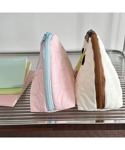 Detail view of quilted heart cotton makeup bags with cute patterns and zipper closure