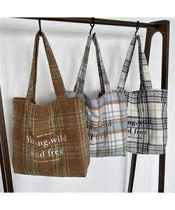 Detailed embroidery text on three vintage plaid tote bags in brown and blue colors
