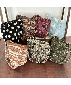 Collection of plush bucket bags with leopard print and geometric patterns on wood
