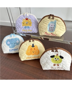 Detailed view of heart-quilted cosmetic bags with cartoon embroidery and bear zippers