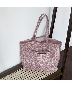 Detail view of pink leopard print tote bag with external pocket and sturdy shoulder straps