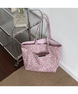 Detail of pink leopard print canvas tote bag with front pocket and woven label detail
