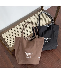 Detail of waterproof nylon tote bags showing stylish animal print lining and beyou merci print