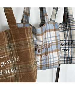 Detailed embroidery on vintage plaid wool tote bags in various stylish autumn colors
