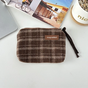 Detail of checkered plush mini pouch with zipper and thick woven lanyard strap