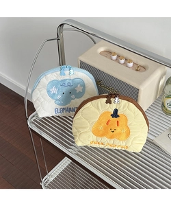 Detail of quilted makeup bags with cute elephant and bell pepper embroidery and bear zippers