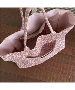 Detail view showing multi-pocket interior layout and large capacity of pink leopard tote bag