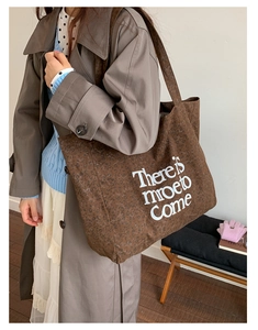 Detail of large leopard print canvas tote bag with white There is more to Come text