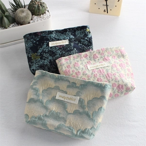 Detailed view of floral canvas storage pouches with high-quality jacquard fabric textures
