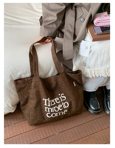Detail of large brown leopard print canvas tote bag in a warm lifestyle fashion setting