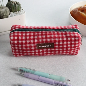 Close-up of red and white plaid pencil case with soft wool texture and green zipper