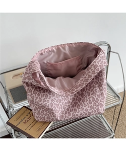 Detailed interior of the leopard print tote bag featuring a spacious pocket and satin lining