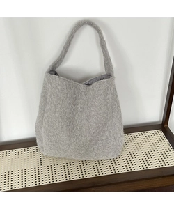 Detailed close-up of thick grey plush wool bucket bag with soft textured surface