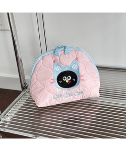 Detail of pink quilted cosmetic bag with cat embroidery and blue bear zipper pulls