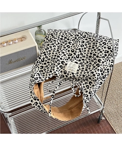 Macro view of leopard print tote bag featuring drawstring closure and textured fabric