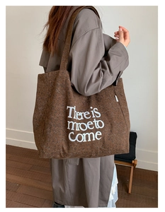 Detail of leopard print canvas tote bag featuring white There is more to Come typography
