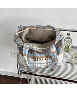 Close-up of vintage plaid wool tote bag showing internal zipper pocket and embroidery