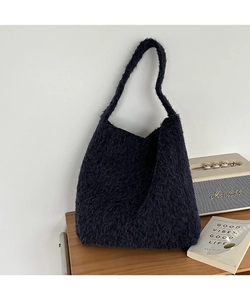 Detail of plush wool bucket bag featuring soft fuzzy texture and large storage capacity
