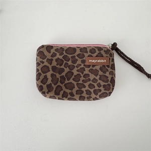 Detail view of leopard print canvas coin purse with pink zipper and wrist strap