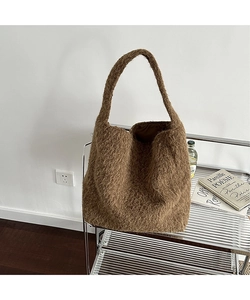 Detailed macro shot of the premium dark brown plush fabric texture on a large tote bag