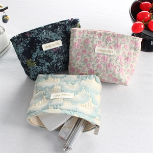 Three-piece floral canvas cosmetic bags with zipper closure for travel storage