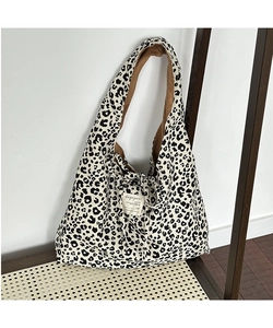 Close-up of leopard print corduroy tote bag showing interior lining and magazine label